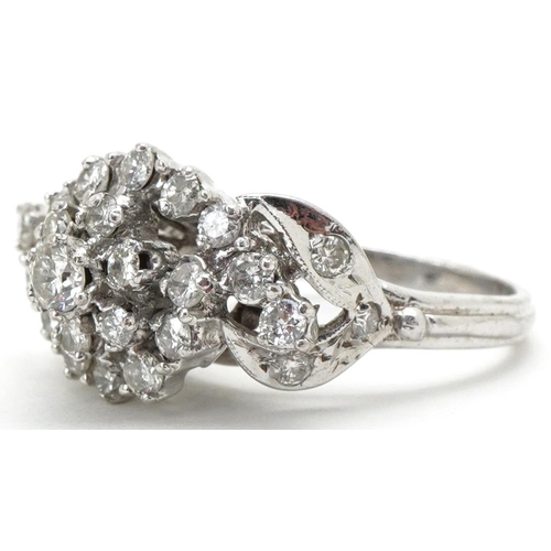 3192 - White metal diamond flower head cocktail ring, total diamond weight approximately 1.10 carat, size O... 