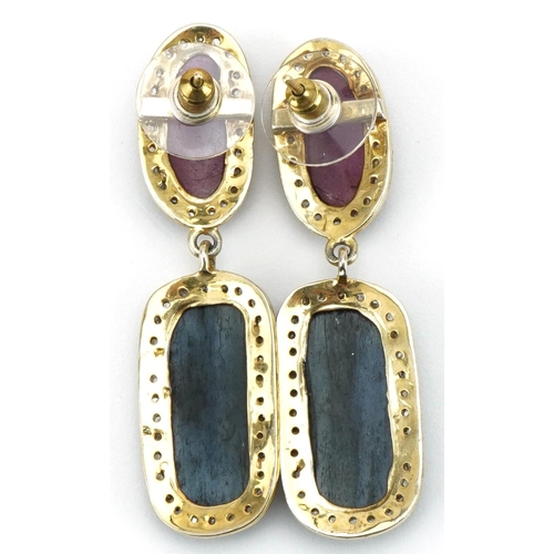 3063 - Pair of large gilt metal drop earrings set with diamonds and mixed rose cut red and blue sapphires, ... 