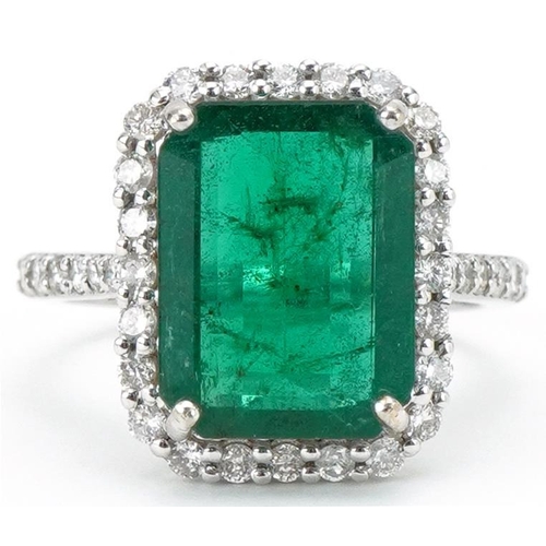 18ct white gold emerald and diamond cluster ring with diamond set shoulders, the emerald approximately 4.94 carat, total diamond weight approximately 0.65 carat, size N, 5.5g