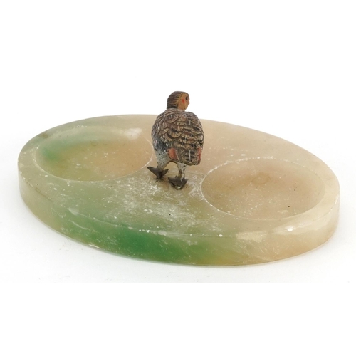 1407 - Austrian cold painted bronze bird on an oval onyx base, 18cm wide