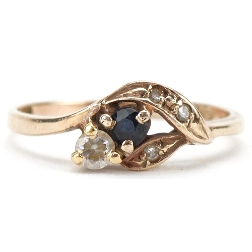 3149 - 9ct gold diamond, sapphire and clear stone crossover ring, size N/O, 1.6g