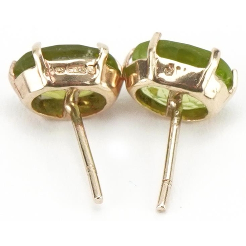 3154 - Pair of 9ct gold green stone stud earrings, 9mm high, total 1.0g