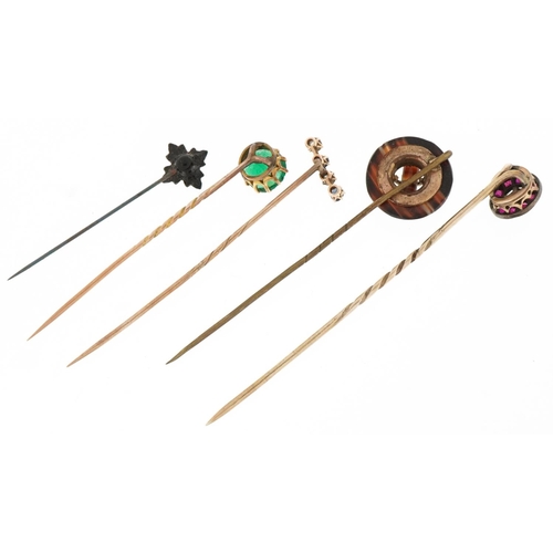 3170 - Five antique gold and yellow metal stickpins housed in three boxes including Scottish agate, diamond... 