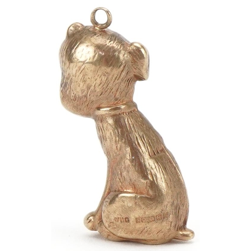 3225 - 9ct gold charm in the form of a seated dog, 2.6cm high, 1.5g