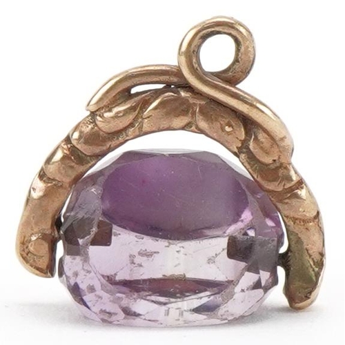 3184 - Unmarked gold amethyst spinner fob, 1.6cm wide, 2.6g