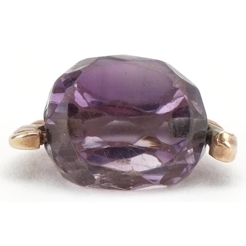 3184 - Unmarked gold amethyst spinner fob, 1.6cm wide, 2.6g