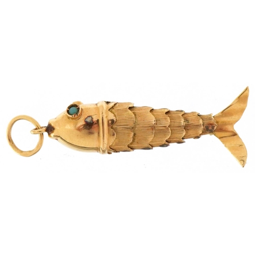 3214 - Continental gold articulated fish charm with turquoise eyes, 3.8cm in length, 1.7g