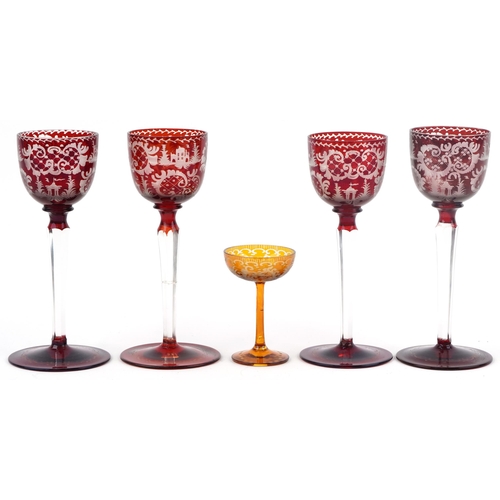 252 - Four Bohemian red flashed glasses etched with wild animals and foliage together with an amber glass ... 