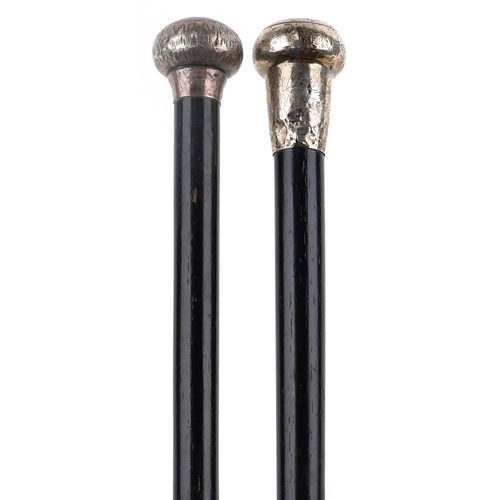 223 - Two ebonised walking sticks with silver handles, 91cm in length