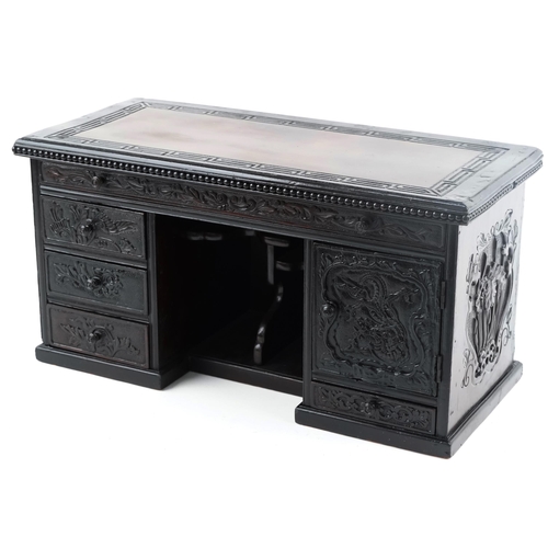 Chinese carved wood table top cabinet in the form of a desk fitted with a series of drawers, 33cm H x 64cm W x 28cm D