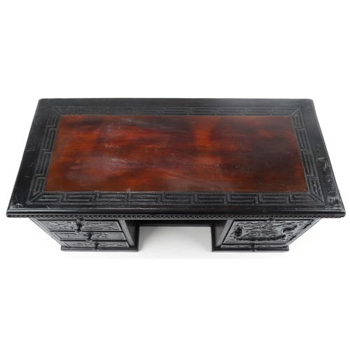 340 - Chinese carved wood table top cabinet in the form of a desk fitted with a series of drawers, 33cm H ... 