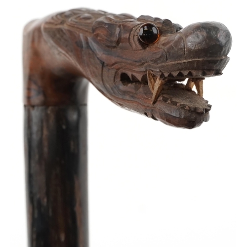 1424 - Rosewood walking stick with carved Chinese dragon head handle, 90cm in length