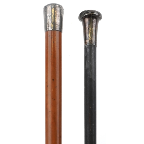 224 - Two malacca and ebonised walking sticks with silver handles, the largest 90cm in length