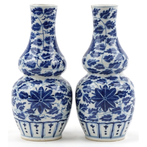 147 - Pair of Chinese blue and white porcelain double gourd vases hand painted with foliage, 24cm high