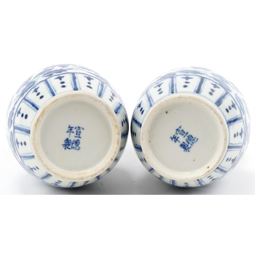 147 - Pair of Chinese blue and white porcelain double gourd vases hand painted with foliage, 24cm high