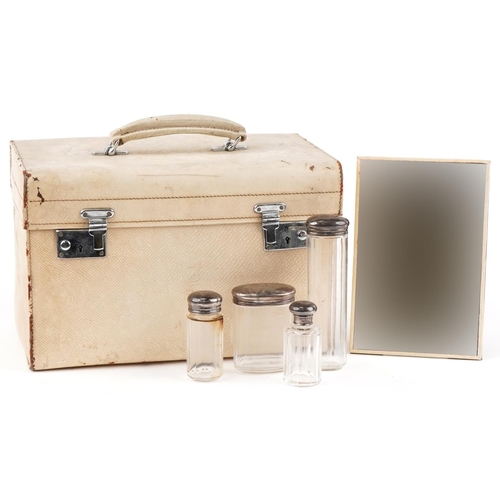 482 - Vintage cream leather travelling vanity case with five glass jars with silver tops, 36cm wide