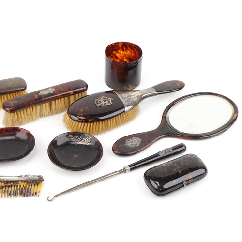 129 - Collection of tortoiseshell and faux tortoiseshell vanity items, some with silver mounts, including ... 