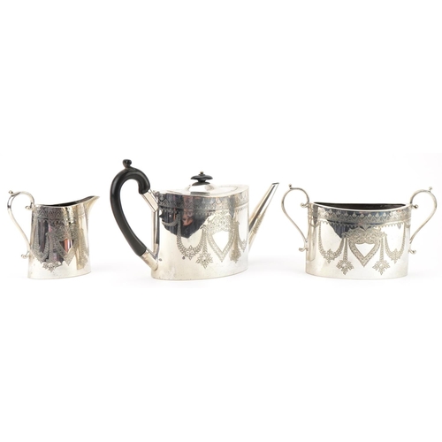 1229 - Silver plated three piece tea service engraved with swags and flowers, the teapot with ebonised hand... 