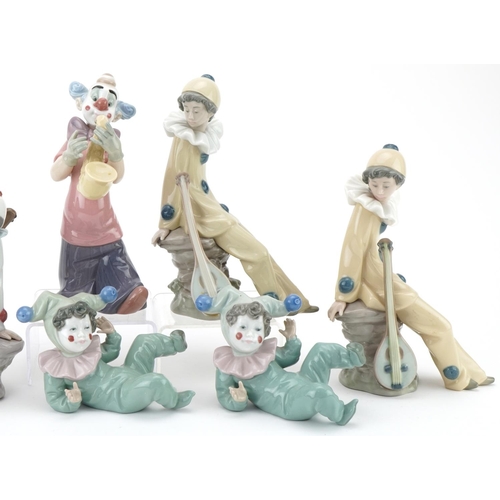 491 - Six Nao porcelain clowns and girl with puppy, the largest 19cm high