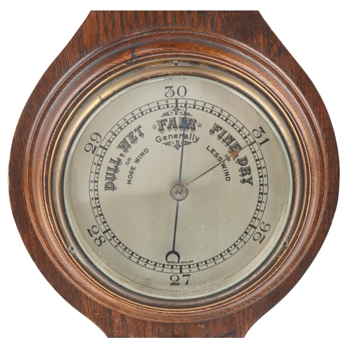 234 - Carved oak wall barometer with silvered dial, 73cm high