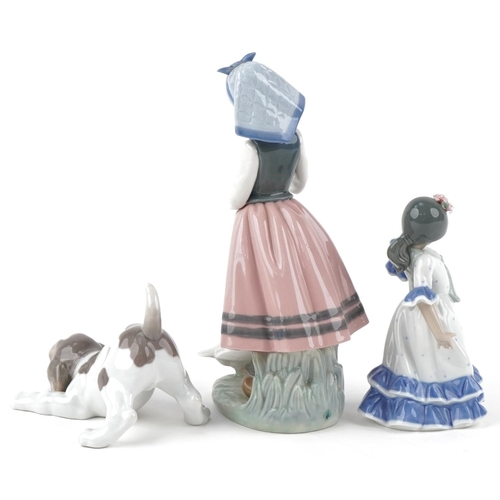 496 - Two Lladro figurines and a puppy with certificates, the largest 26cm high