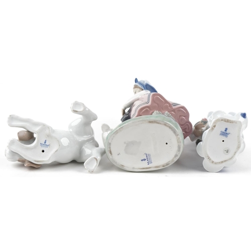 496 - Two Lladro figurines and a puppy with certificates, the largest 26cm high