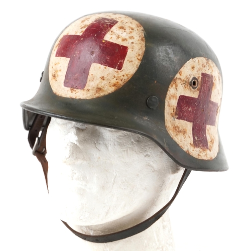 German military World War II combat helmet with medic inscriptions