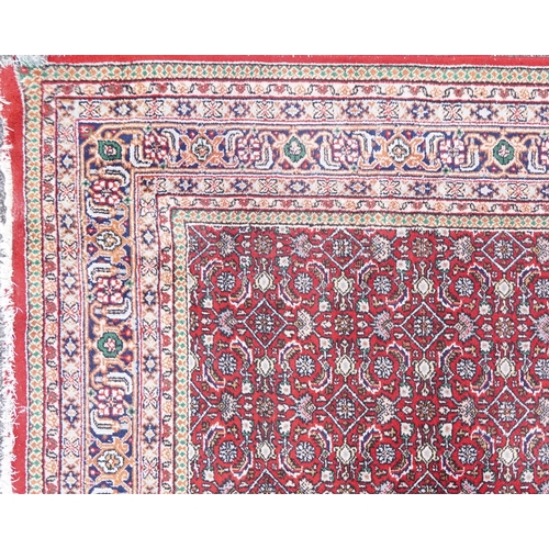 1016 - Rectangular Persian Bidjar rug having and allover geometric design onto a red ground, 250cm x 200cm