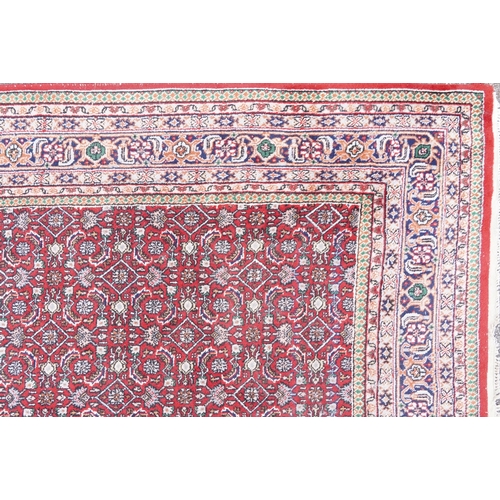 1016 - Rectangular Persian Bidjar rug having and allover geometric design onto a red ground, 250cm x 200cm