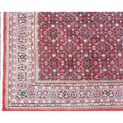 1016 - Rectangular Persian Bidjar rug having and allover geometric design onto a red ground, 250cm x 200cm