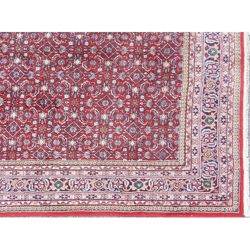 1016 - Rectangular Persian Bidjar rug having and allover geometric design onto a red ground, 250cm x 200cm