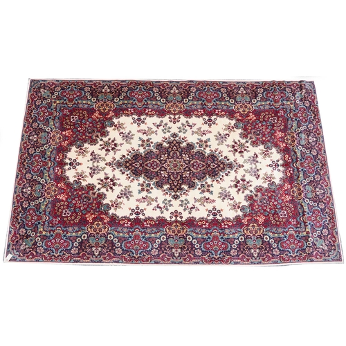 1015 - Rectangular Persian Tabriz rug having and allover floral design onto a cream, red and blue ground, 3... 