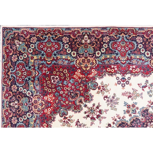 1015 - Rectangular Persian Tabriz rug having and allover floral design onto a cream, red and blue ground, 3... 