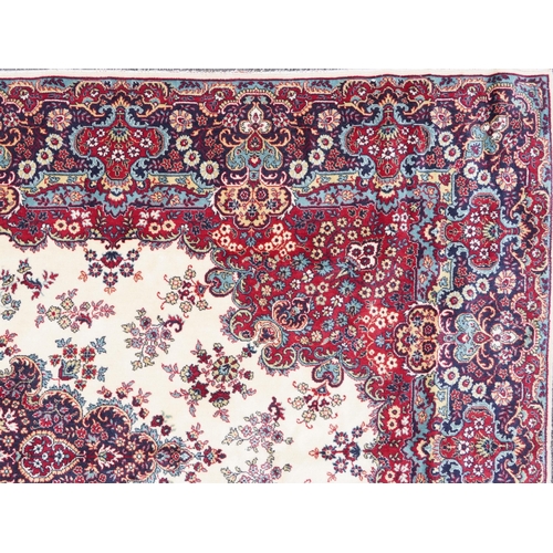 1015 - Rectangular Persian Tabriz rug having and allover floral design onto a cream, red and blue ground, 3... 