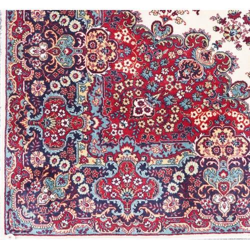 1015 - Rectangular Persian Tabriz rug having and allover floral design onto a cream, red and blue ground, 3... 