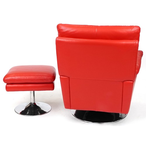 735 - Modern red leather revolving armchair with matching footstool, both on chromium plated circular base... 