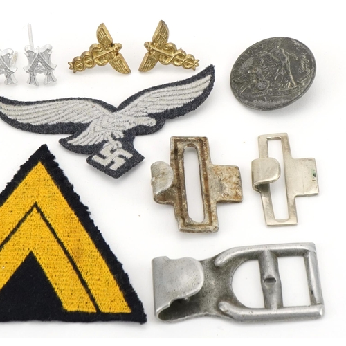 2585 - German military World War II ephemera including cloth patches, insignia and buckles