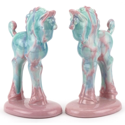 30 - Pair of Art Deco porcelain pink and blue glazed horses, 21cm high