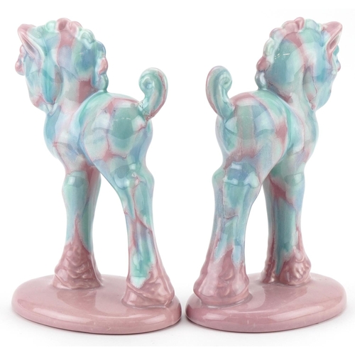 30 - Pair of Art Deco porcelain pink and blue glazed horses, 21cm high