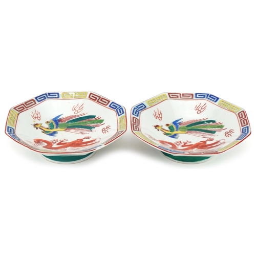 1414 - Pair of Chinese octagonal footed bowls hand painted with dragons and phoenixes, 18cm in diameter