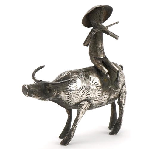 366 - Middle Eastern white metal study of a figure seated on a cow, 10cm in length, 51.2g