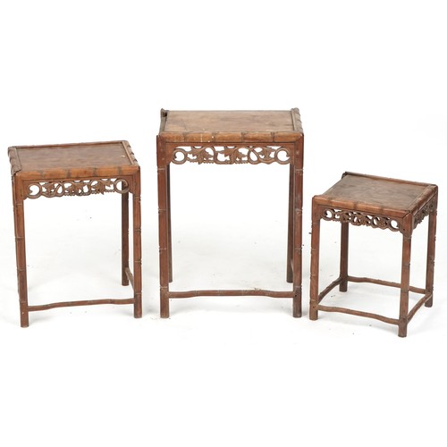 717 - Nest of three Chinese hardwood tables, early 20th century, with carved friezes above faux bamboo tur... 