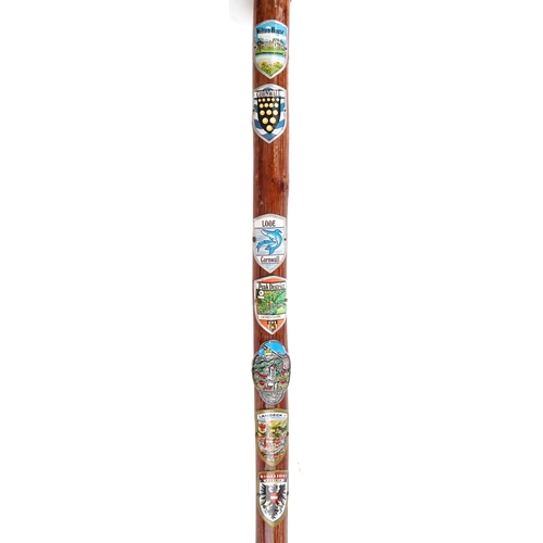 1429 - Swiss bentwood walking stick and a similar British example, each with applied shields including Inte... 