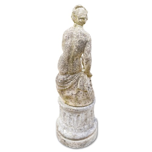 769 - 20th century cast composition stone garden figure of a seated maiden on a concrete circular plinth, ... 