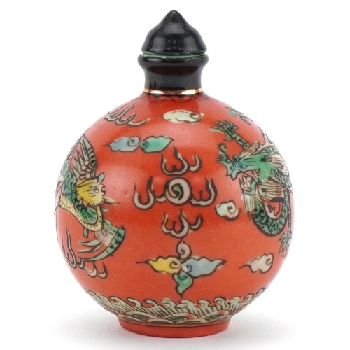 102 - Chinese porcelain scent bottle with stopper hand painted with a dragon and phoenix amongst clouds, f... 