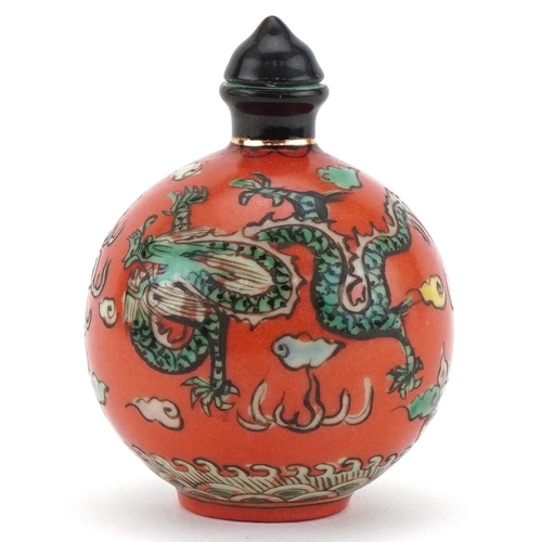 102 - Chinese porcelain scent bottle with stopper hand painted with a dragon and phoenix amongst clouds, f... 