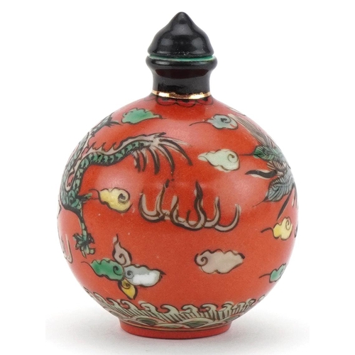 102 - Chinese porcelain scent bottle with stopper hand painted with a dragon and phoenix amongst clouds, f... 