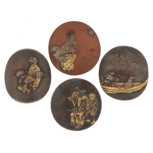 1398 - Japanese Shakudo oval plaques, 19th century, a group of four small copper mounts with figures within... 