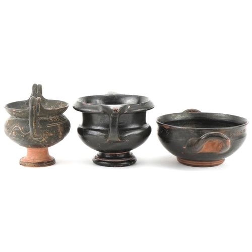 350 - Three Greek black glazed terracotta two handled bowls, circa 400 BC, one with marks to the rim, larg... 