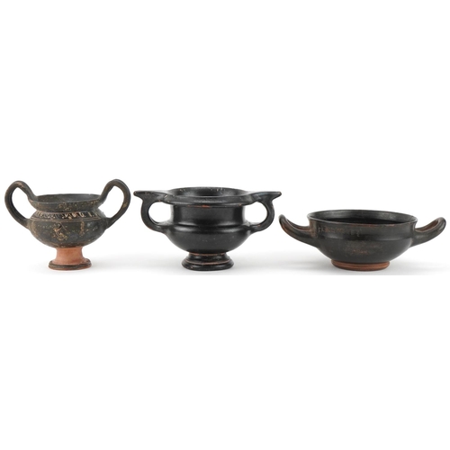 350 - Three Greek black glazed terracotta two handled bowls, circa 400 BC, one with marks to the rim, larg... 